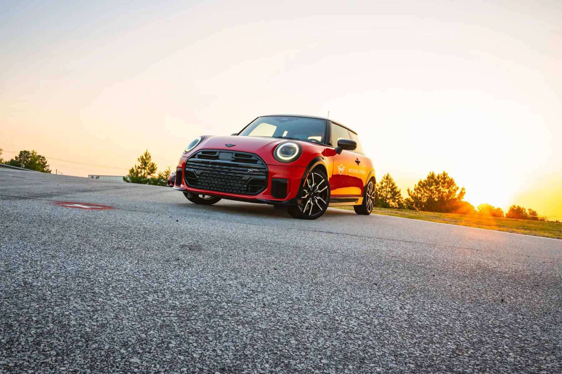 Red MINI Driving Experience car parked on the track at sunset