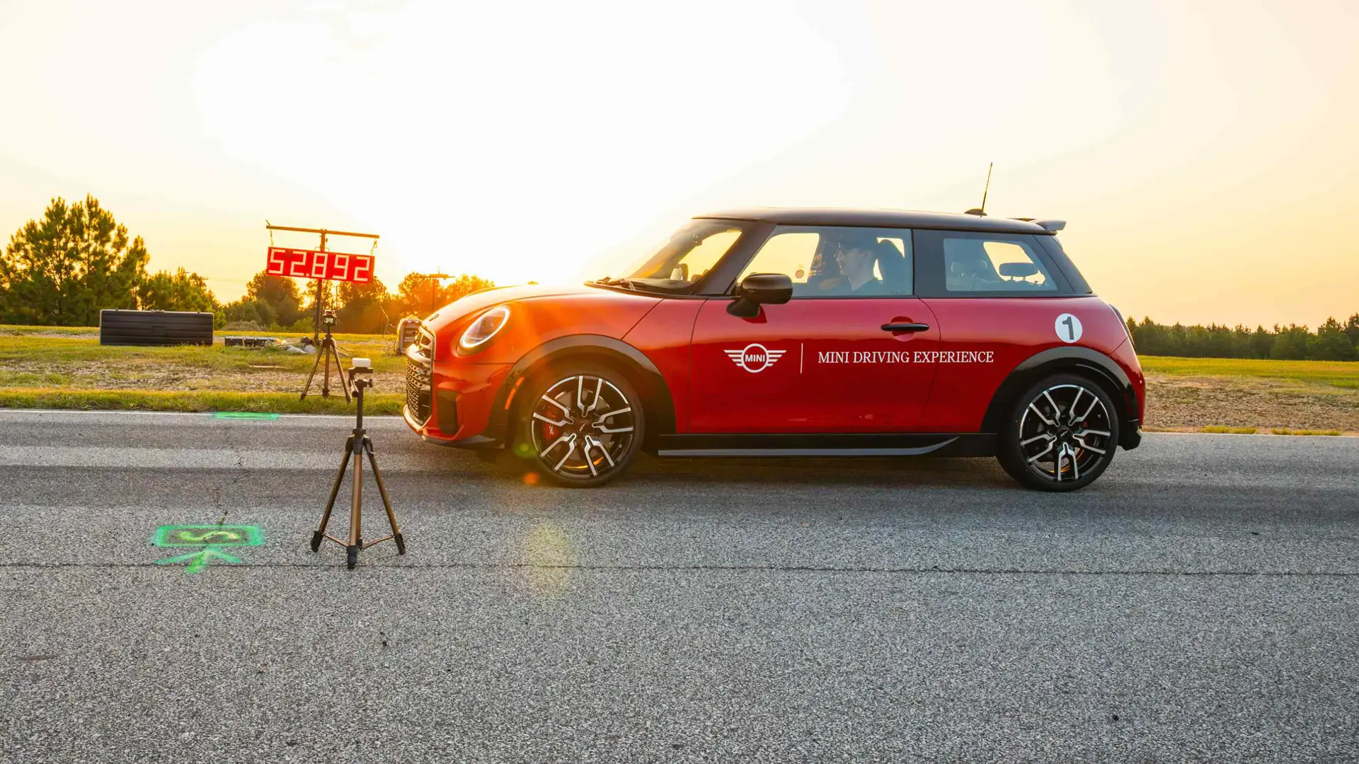 Red MINI beside a timing display reading 52.892 at the end of a timed run